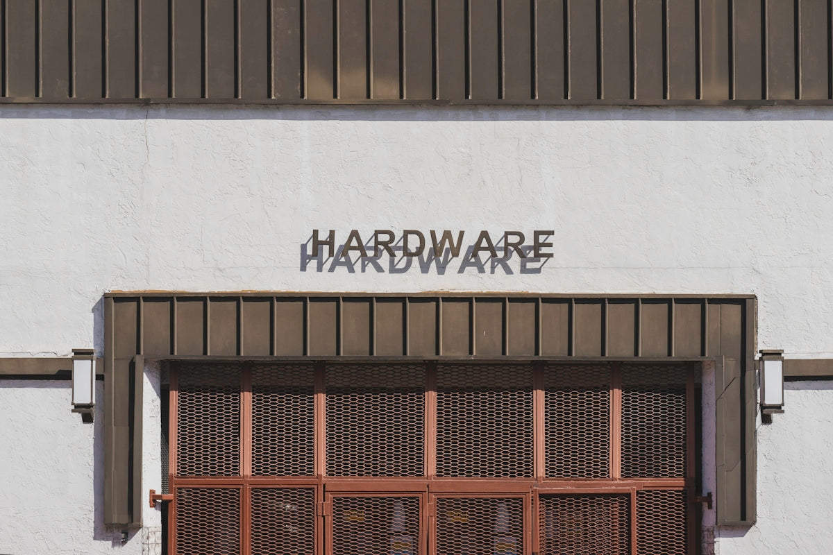 a white building with a sign that says hardware hardware